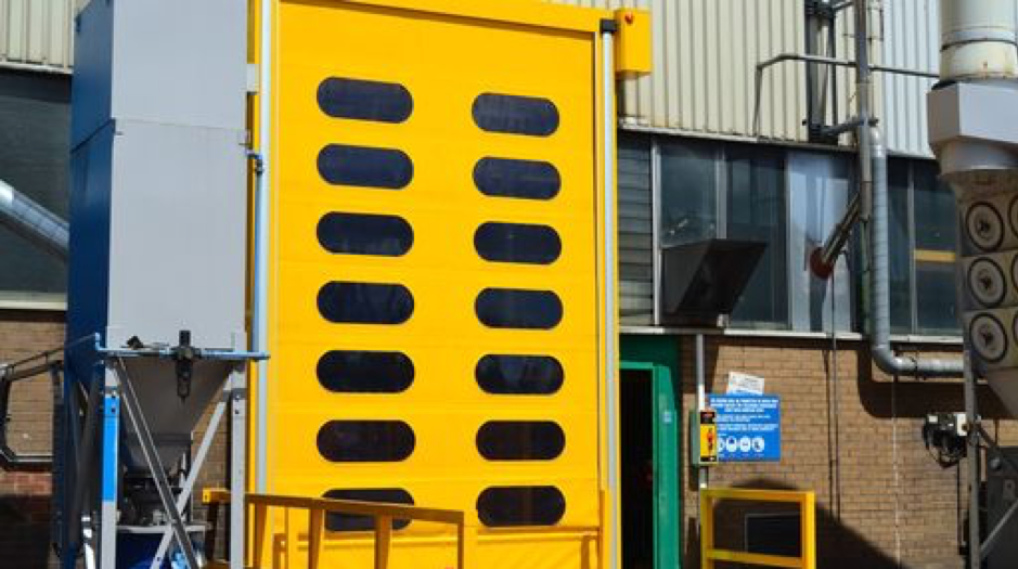 A bright yellow rapid roll door at an industrial property 